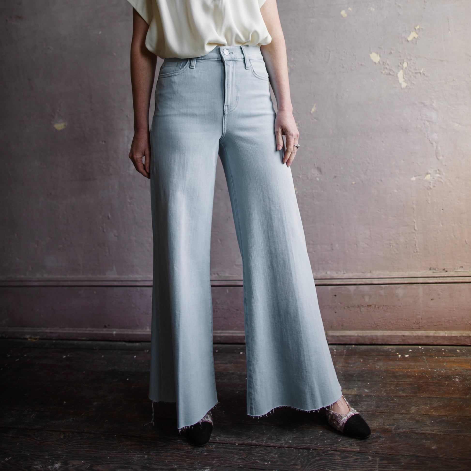 Image featuring a woman wearing  high-rise cropped silhouette jean from Frame with a frayed, swingy hem and crafted from a lightweight, super-stretch cotton blend.