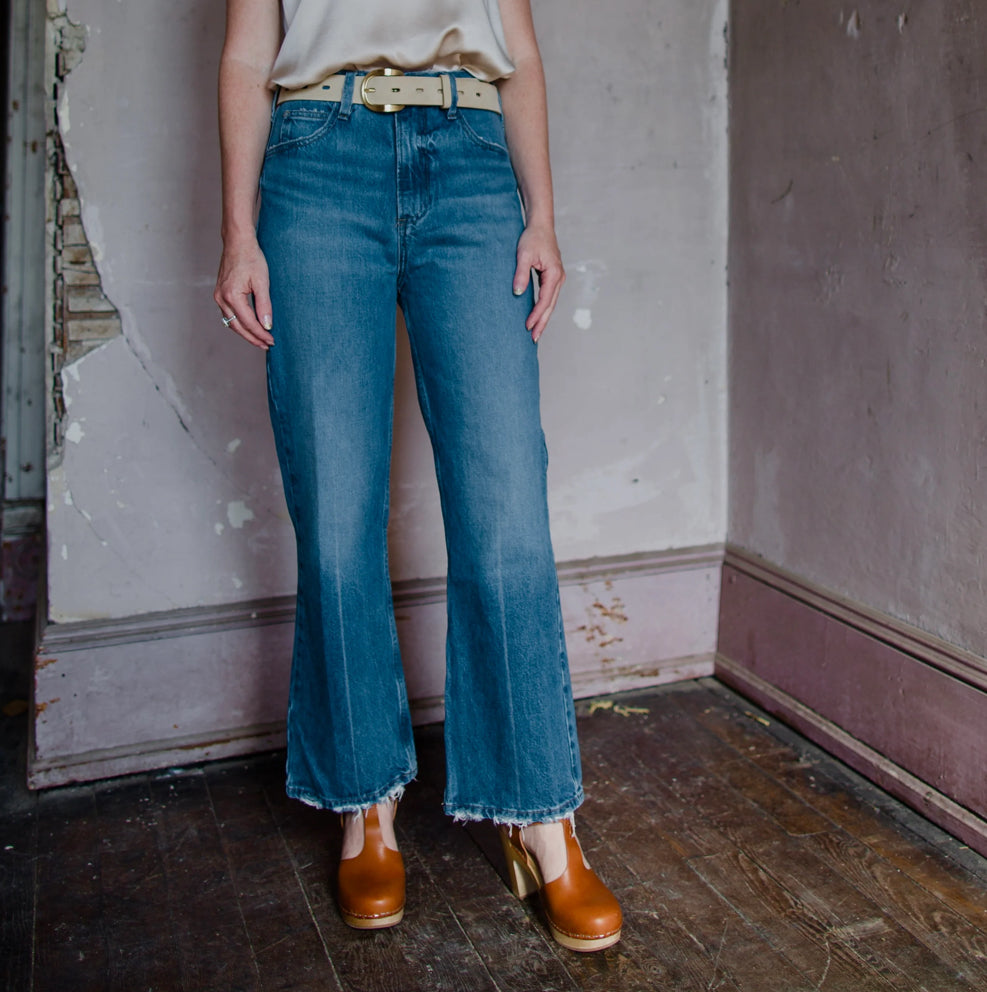 Image featuring a woman wearing the Frame Le High n Tight Crop denim jeans in Del Amo Grind wash.