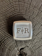 Image of a Fulton and Roark solid fragrance monogrammed metal travel case for refillable solid scent pan 