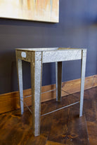 A rectangular galvanized metal tray table with side handles for indoor or outdoor versatility