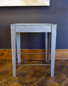 A rectangular galvanized metal tray table with side handles for indoor or outdoor versatility