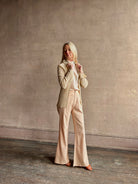 Image of mature woman wearing premium cashmere linen GUEST IN RESIDENCE Breezy Cardigan in Sandstone beige with long sleeves hook and eye front closure and ribbed texture