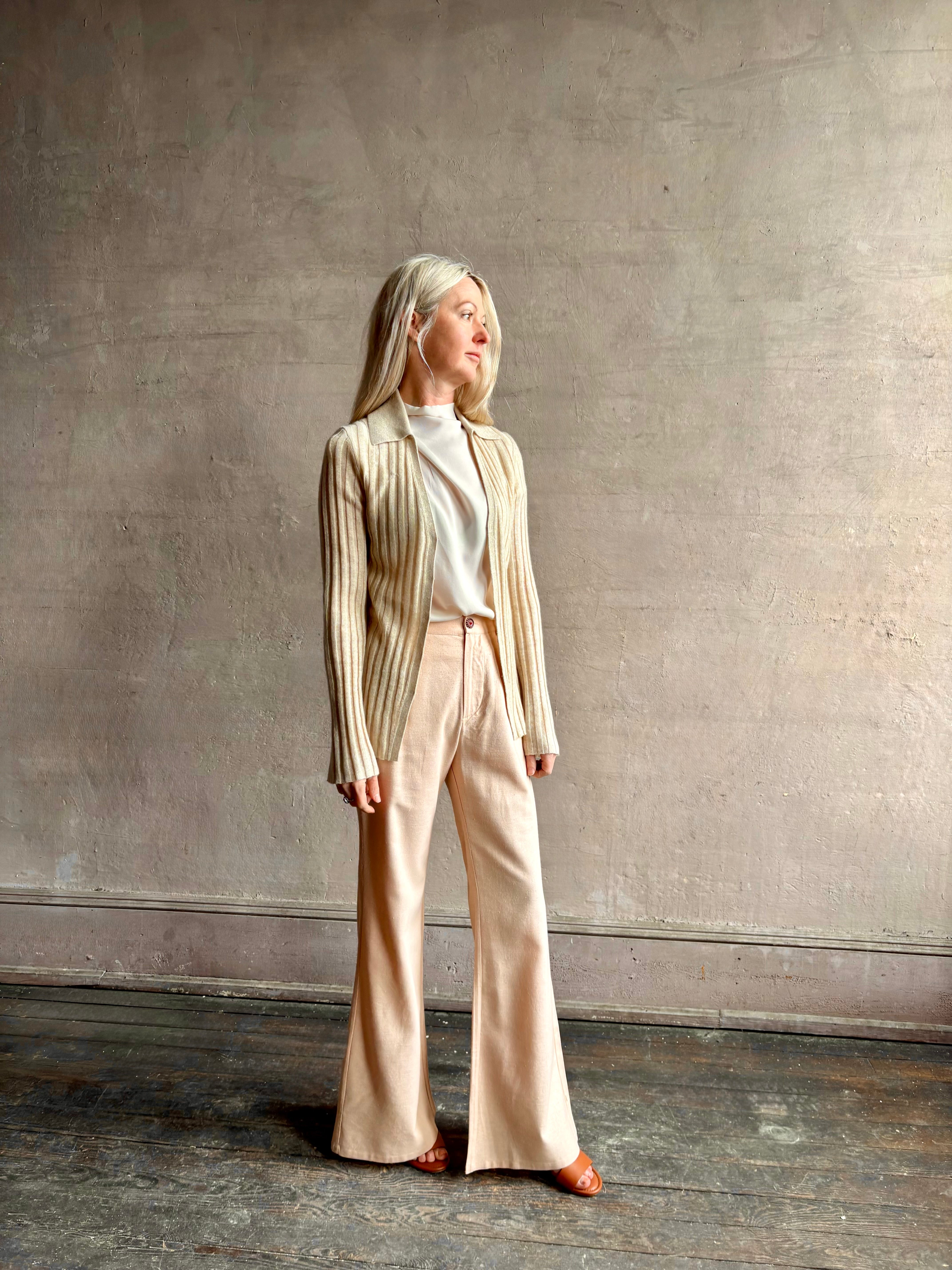 Image of mature woman wearing premium cashmere linen GUEST IN RESIDENCE Breezy Cardigan in Sandstone beige with long sleeves hook and eye front closure and ribbed texture