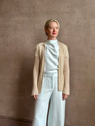 Image of mature woman wearing premium cashmere linen GUEST IN RESIDENCE Breezy Cardigan in Sandstone beige with long sleeves hook and eye front closure and ribbed texture