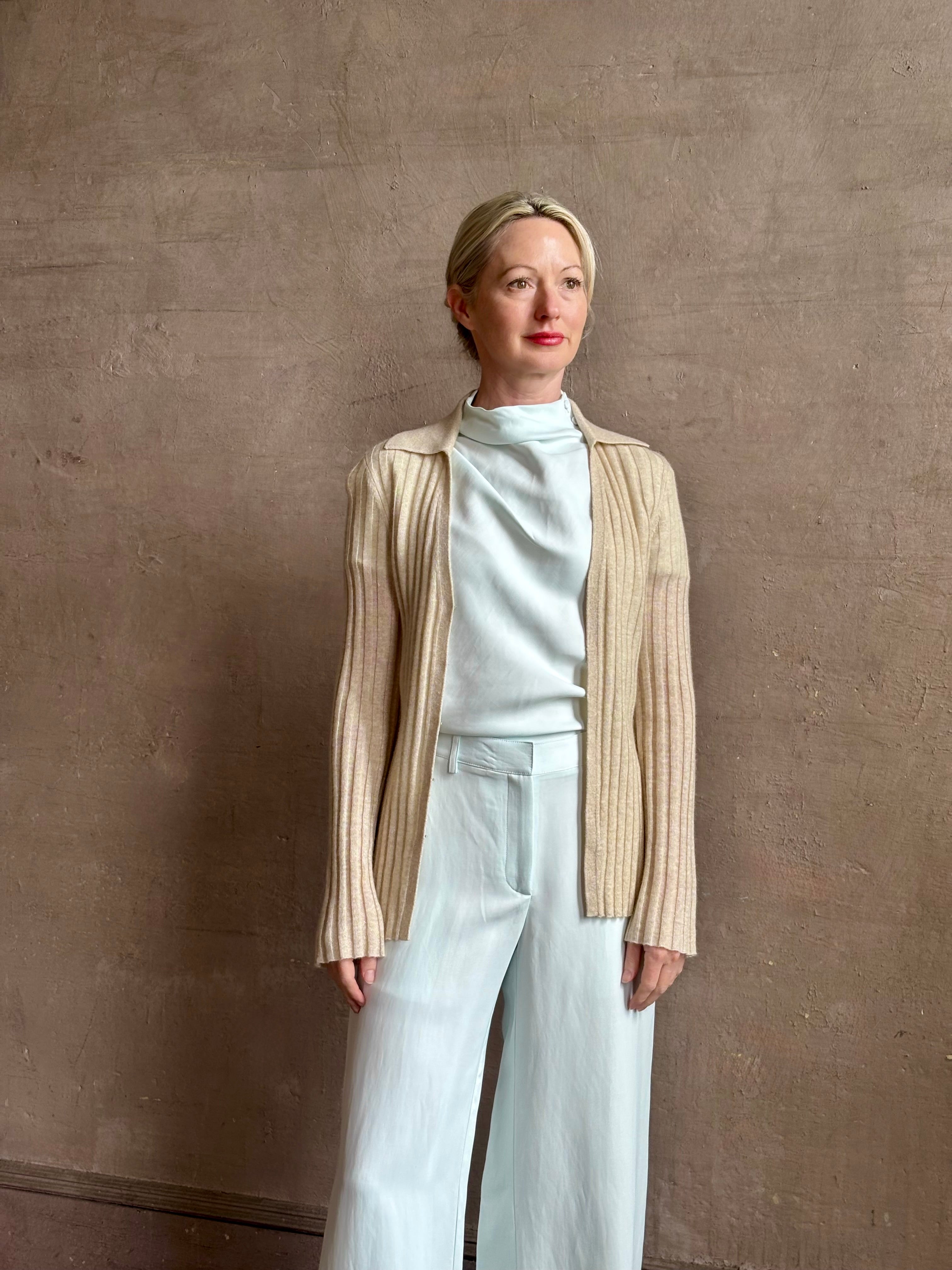 Image of mature woman wearing premium cashmere linen GUEST IN RESIDENCE Breezy Cardigan in Sandstone beige with long sleeves hook and eye front closure and ribbed texture