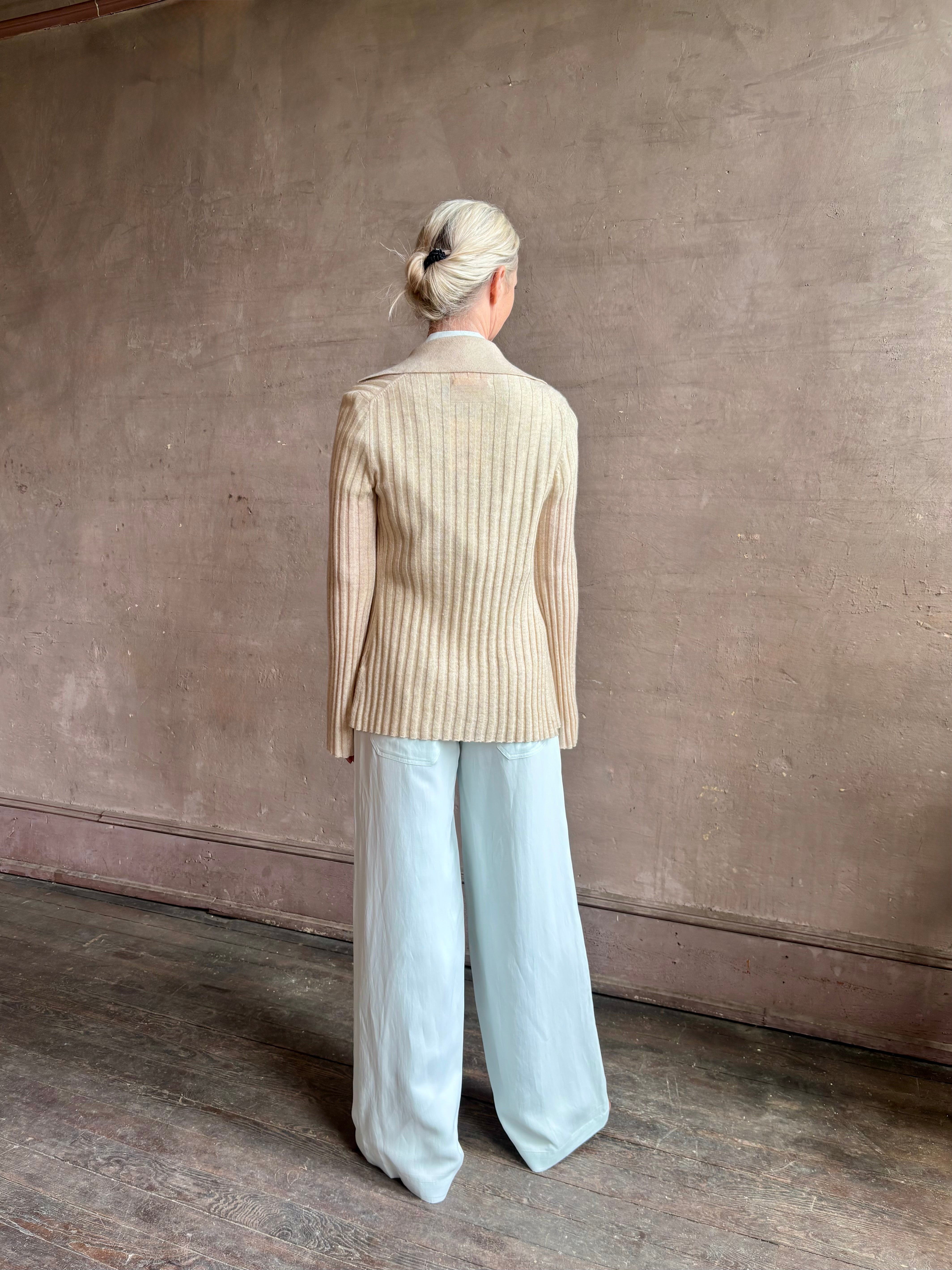 Image of mature woman wearing premium cashmere linen GUEST IN RESIDENCE Breezy Cardigan in Sandstone beige with long sleeves hook and eye front closure and ribbed texture