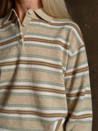 Mature woman wearing Guest in Residence Colliegate beige aqua and white striped cashmere polo sweater