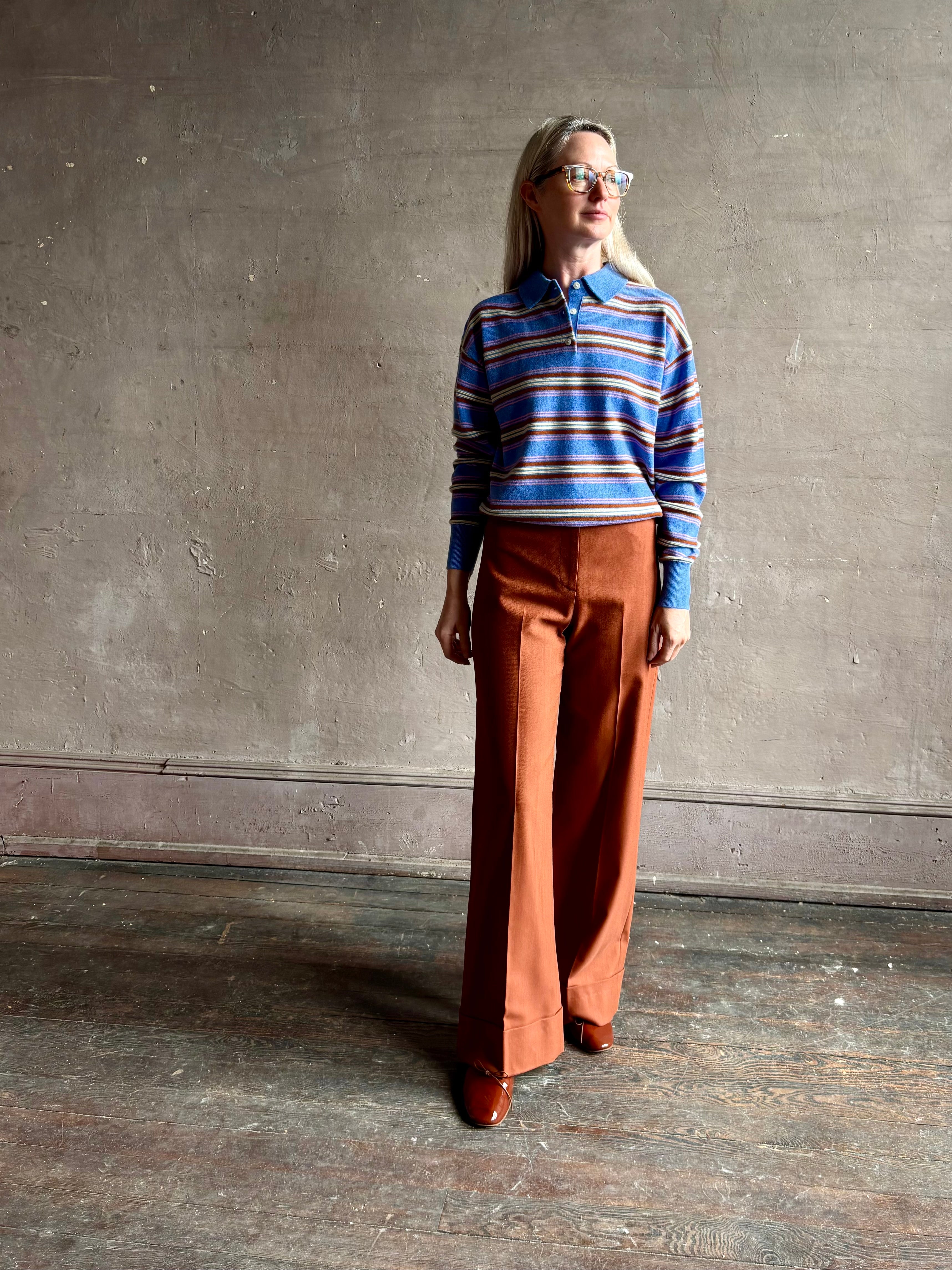 Mature woman wearing luxury women's clothing brand Guest in Residence Colliegate Blue striped polo sweater