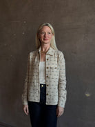 Mature woman wearing Guest in Residence Dylan Tweed Shirt in Sandstone Mongolian cashmere textural tweed finish. Heirloom-quality workwear-inspired overshirt