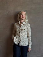 Mature woman wearing Guest in Residence Dylan Tweed Shirt in Sandstone Mongolian cashmere textural tweed finish. Heirloom-quality workwear-inspired overshirt