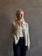 Mature woman wearing Guest in Residence Dylan Tweed Shirt in Sandstone Mongolian cashmere textural tweed finish. Heirloom-quality workwear-inspired overshirt