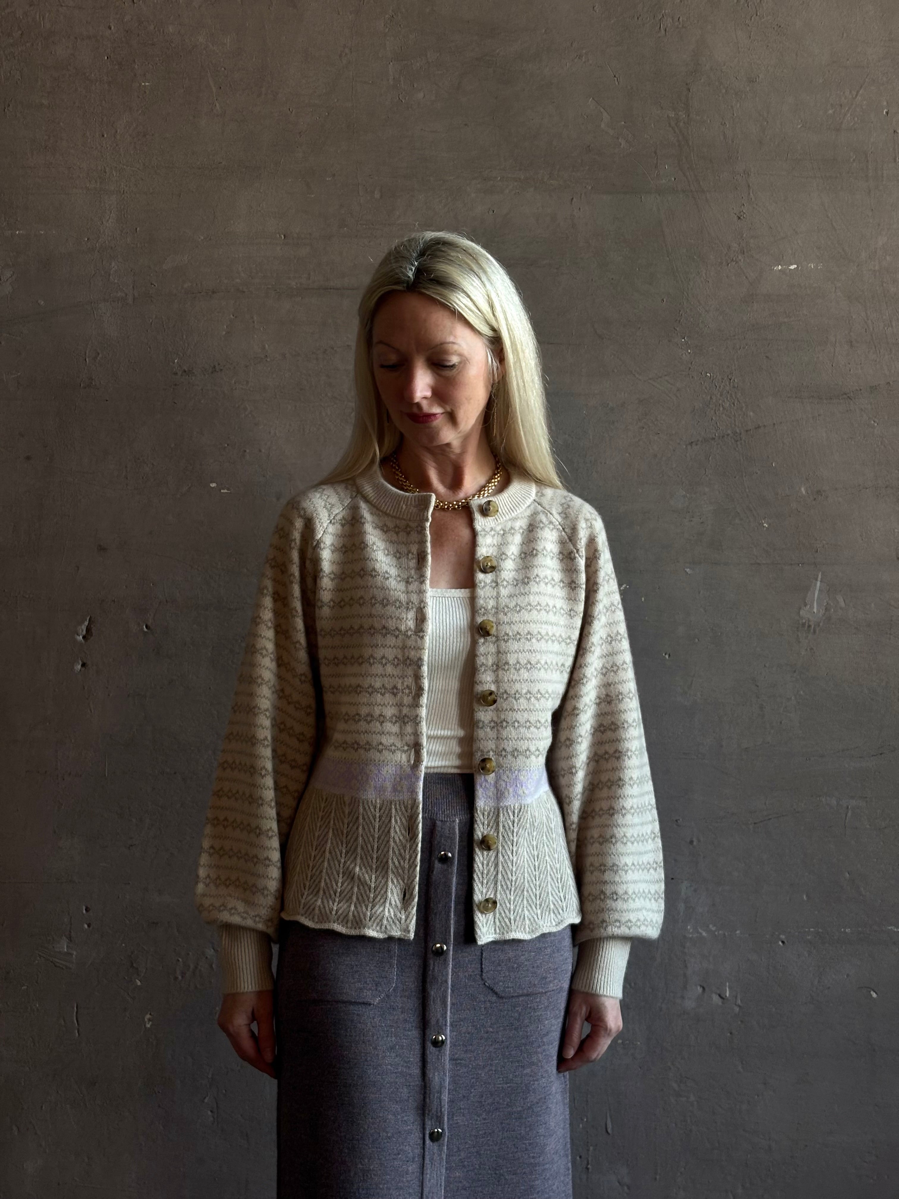 mature woman wearing Guest in Residence Fairisle Cardigan in cream and beige pattern with a subtle lavender  knit accent at waistline