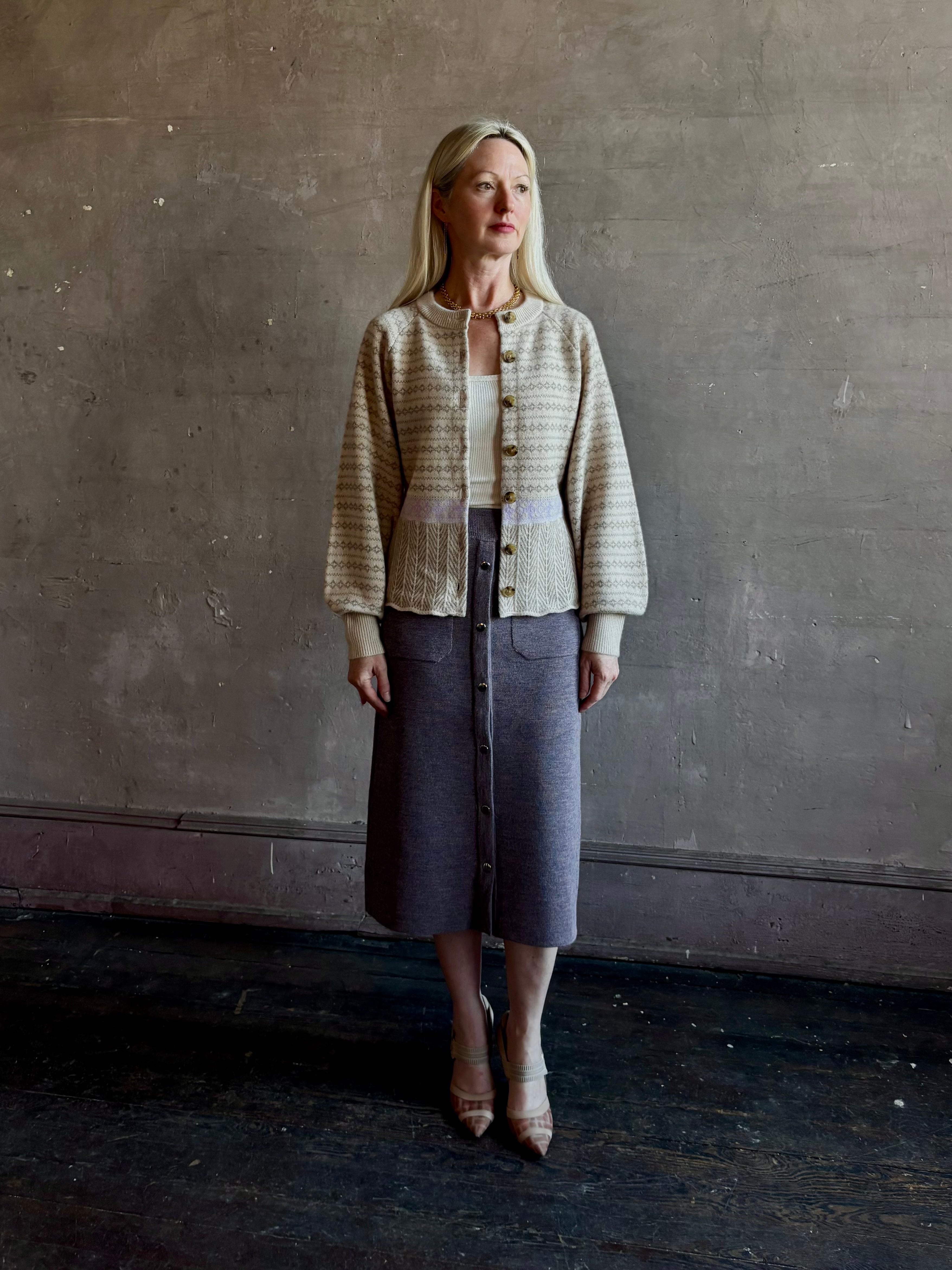mature woman wearing Guest in Residence Fairisle Cardigan in cream and beige pattern with a subtle lavender  knit accent at waistline