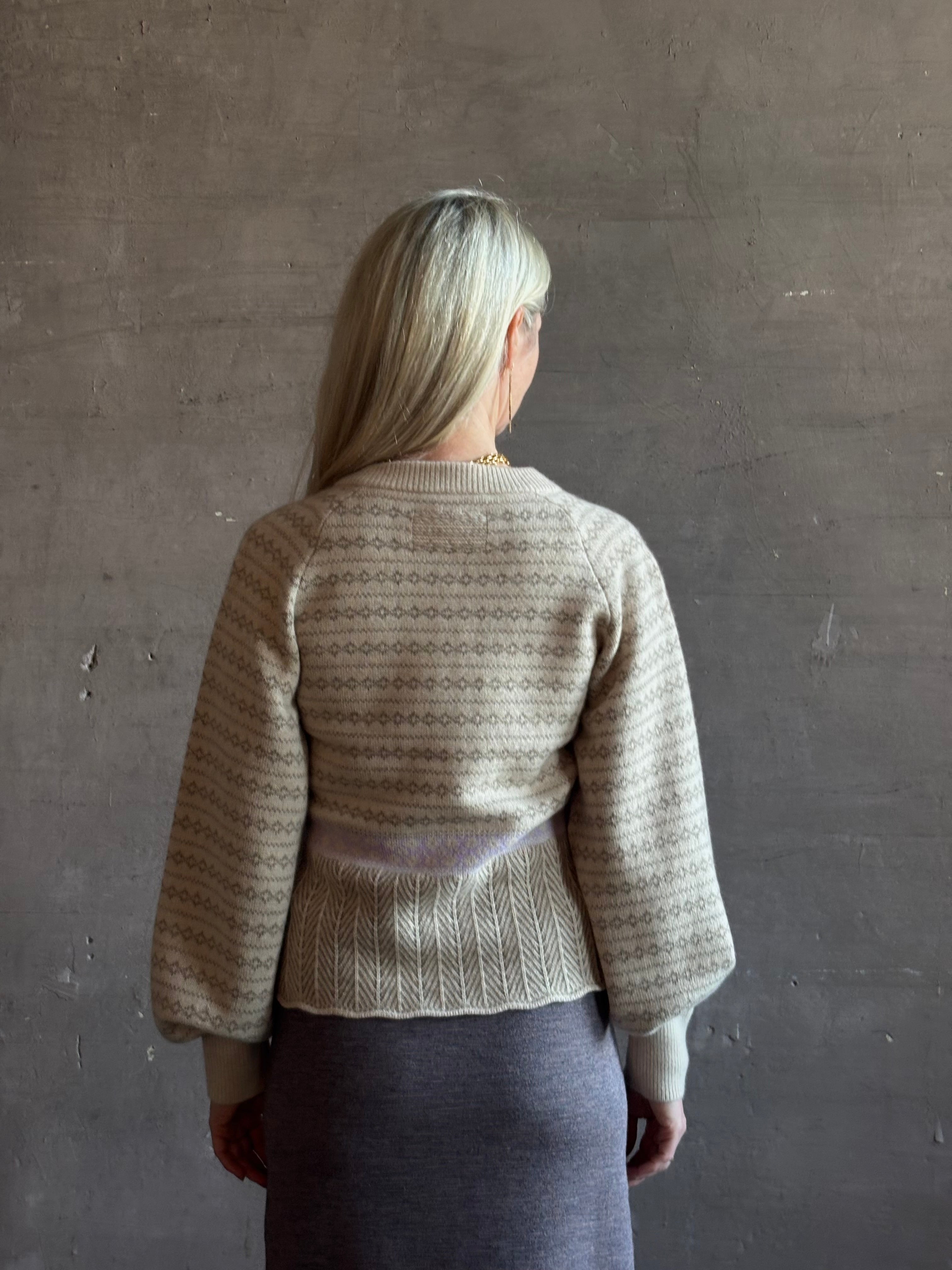 mature woman wearing Guest in Residence Fairisle Cardigan in cream and beige pattern with a subtle lavender  knit accent at waistline