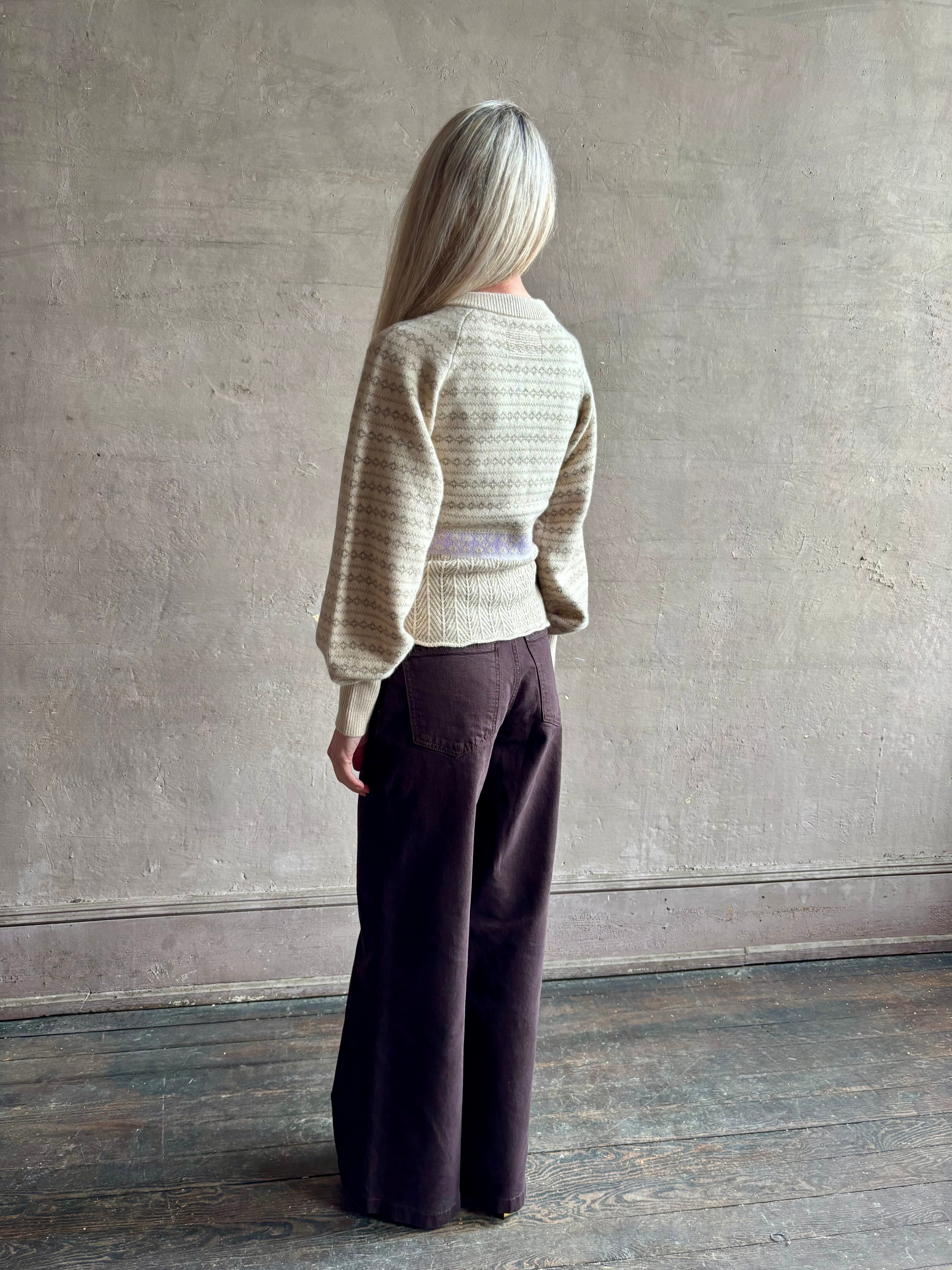 Image of mature woman wearing Guest in Residence Fairisle Cardigan in cream and beige pattern with a subtle lavender  knit accent at waistline