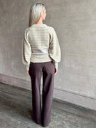 Image of mature woman wearing Guest in Residence Fairisle Cardigan in cream and beige pattern with a subtle lavender  knit accent at waistline