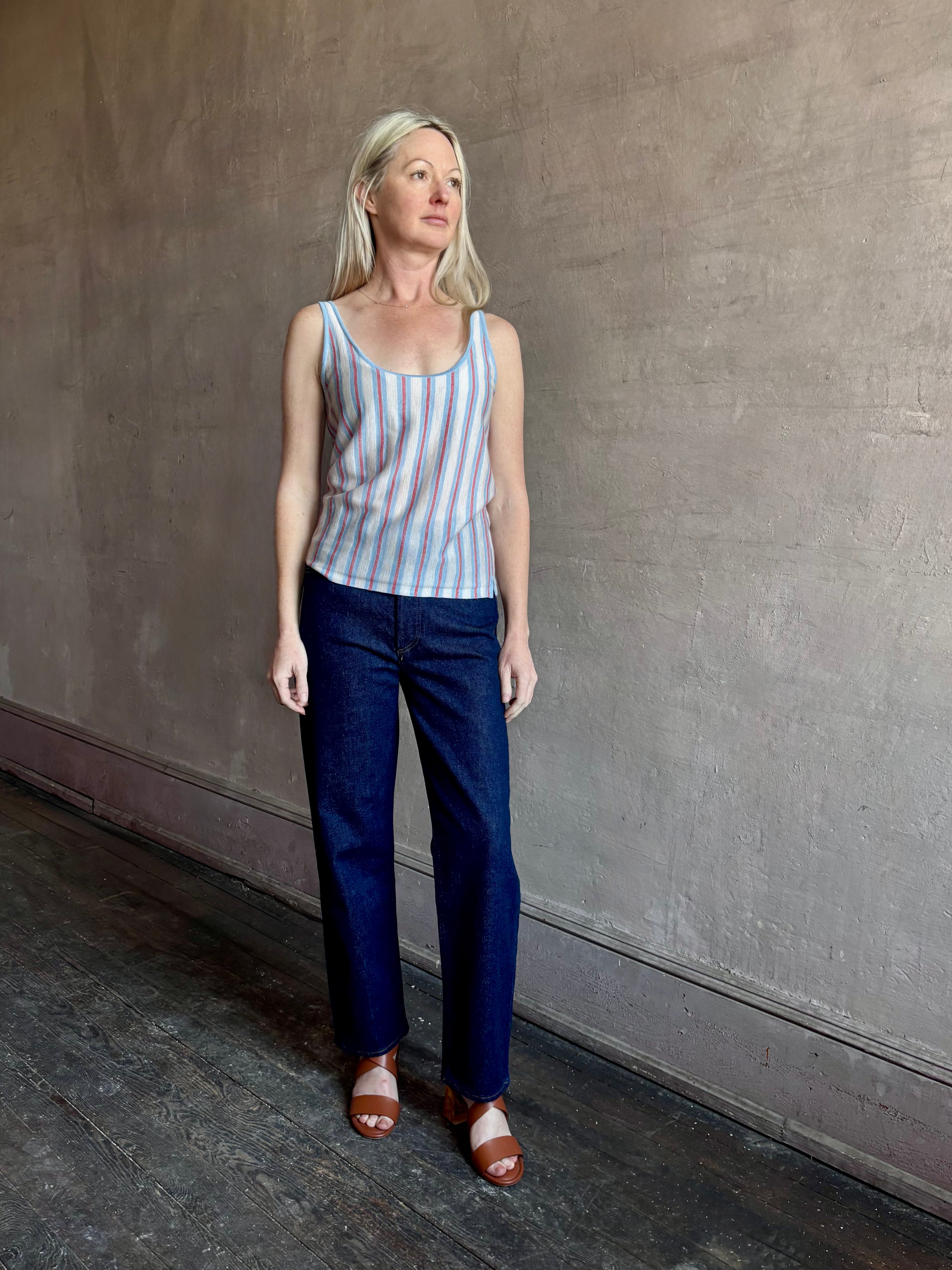 Image of woman wearing lightweight premium Mongolian cashmere GUEST IN RESIDENCE Fine Stripe sleeveless Tank in red and blue stipes with scoop neck