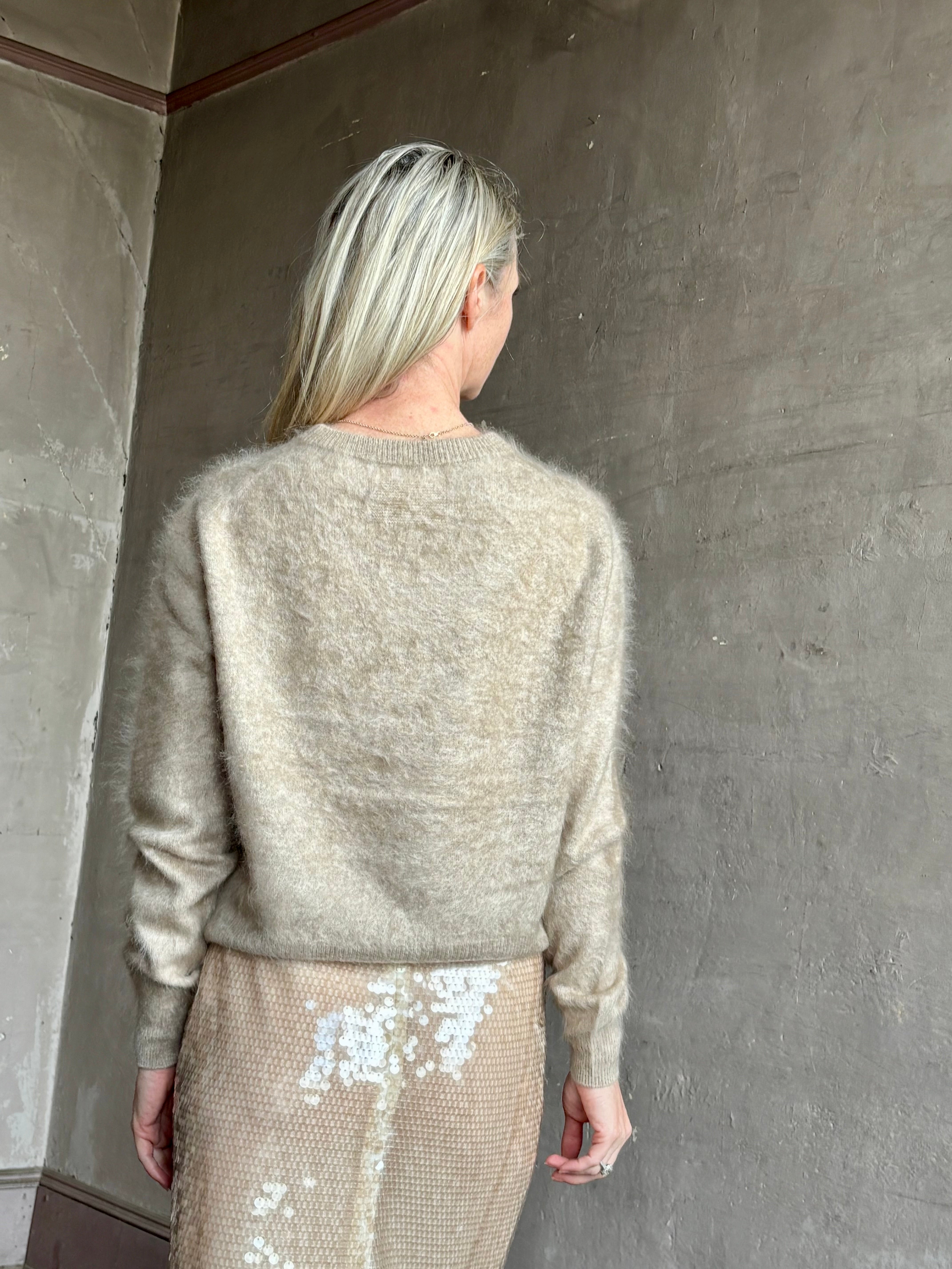 Image of mature model wearing American luxury women's clothing brand Guest In Residence long-sleeve crew neck brushed cashmere beige sweater