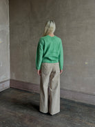 Mature woman wearing Guest in Residence Grizzly Double V Sweater Highland Green brushed cashmere with symmetrical front-and-back V-necklines
