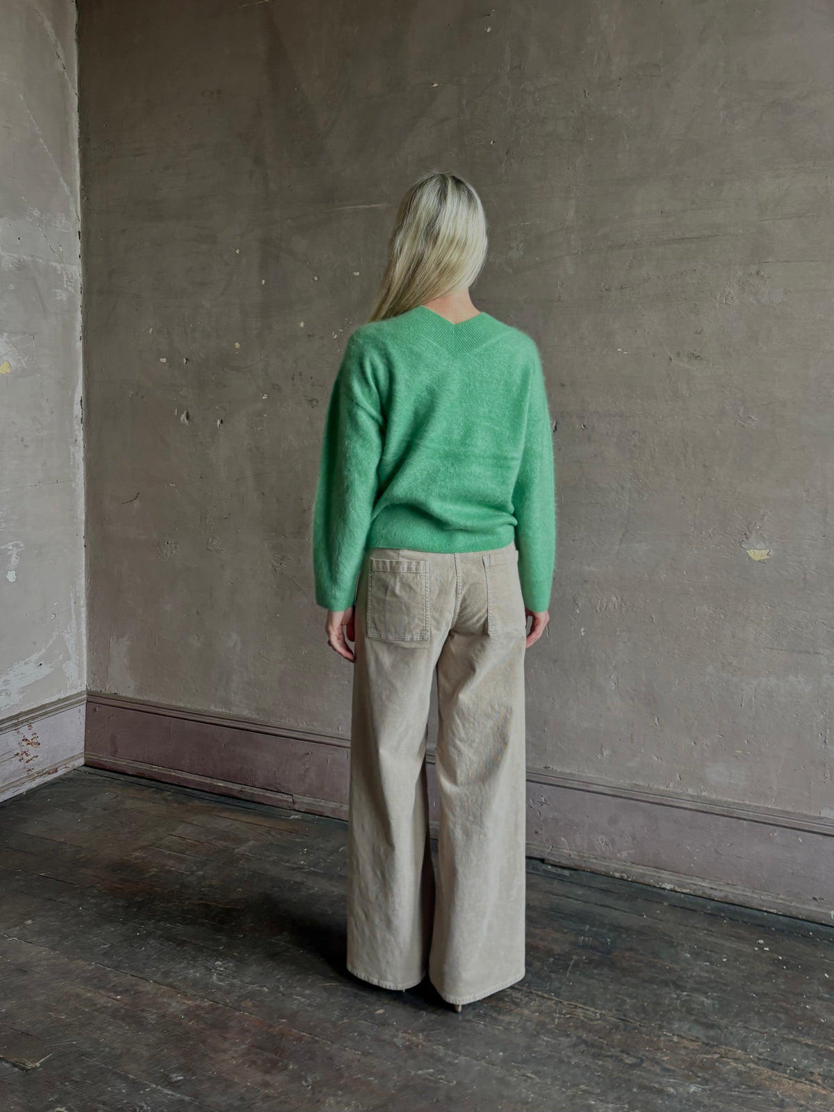 Mature woman wearing Guest in Residence Grizzly Double V Sweater Highland Green brushed cashmere with symmetrical front-and-back V-necklines