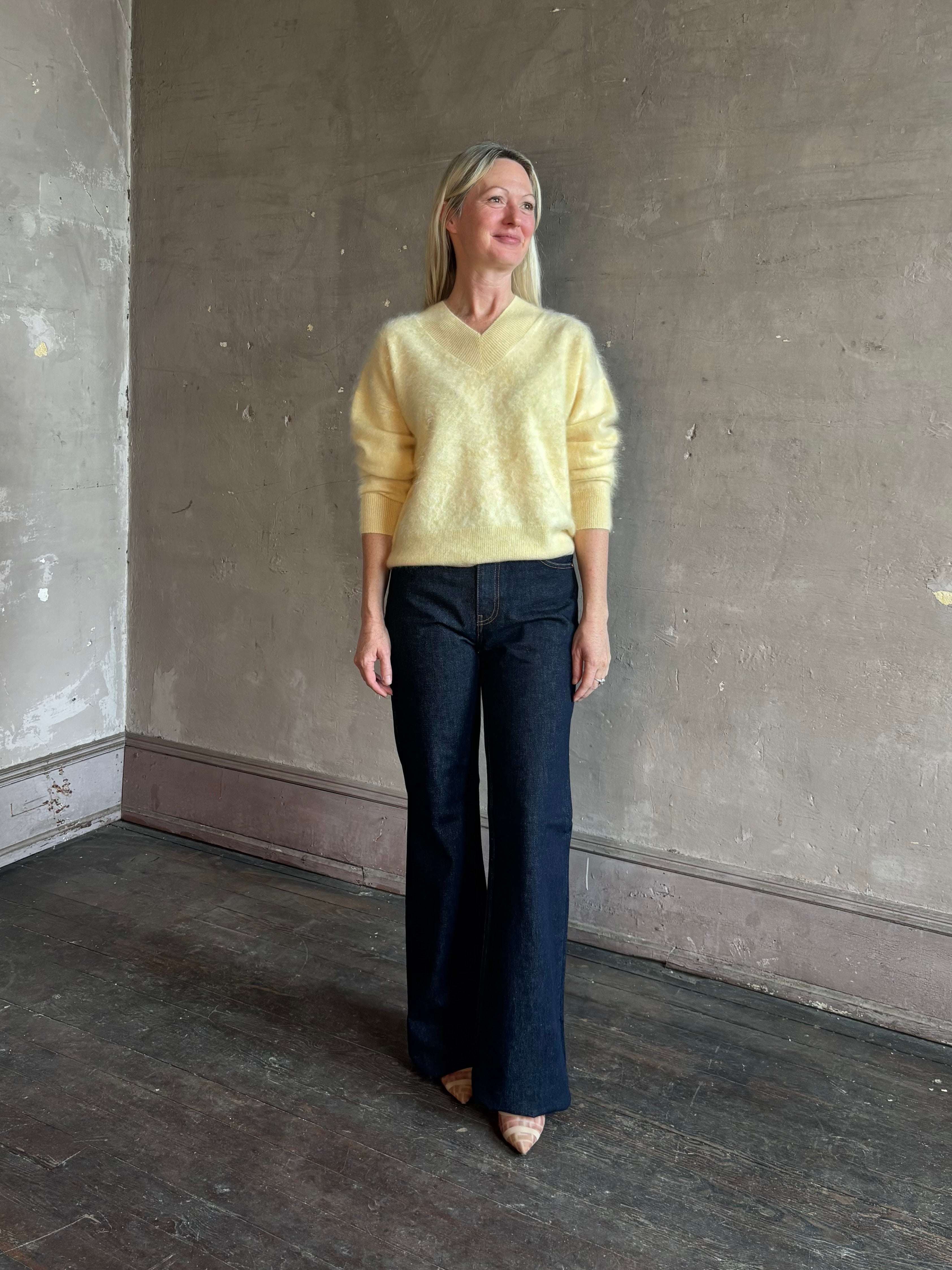 Mature woman wearing Guest in Residence Grizzly Double V Sweater in Butter brushed cashmere front-and-back V-necklines long sleeves