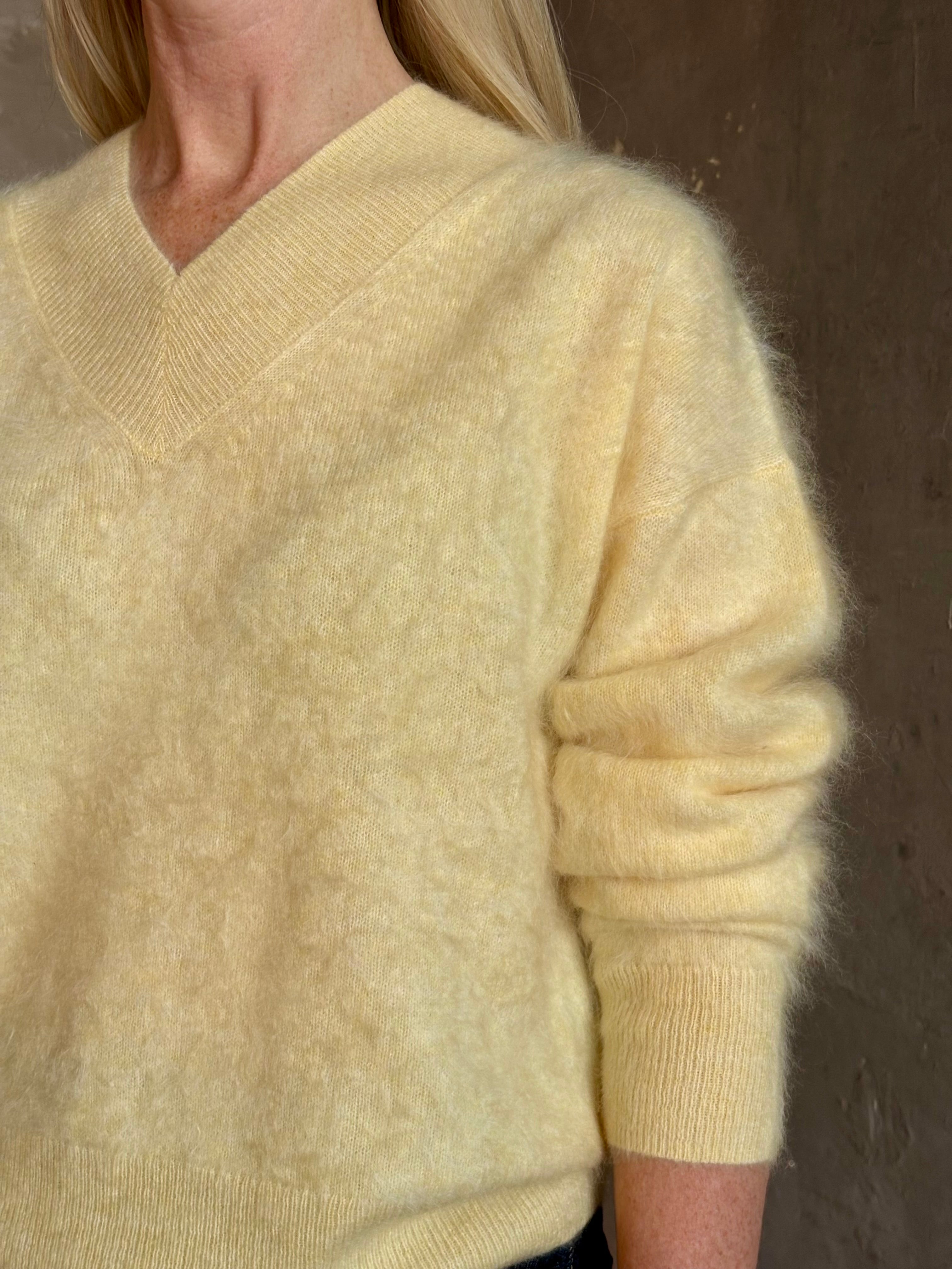 Mature woman wearing Guest in Residence Grizzly Double V Sweater in Butter brushed cashmere front-and-back V-necklines long sleeves