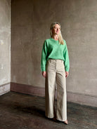 Mature woman wearing Guest in Residence Grizzly Double V Sweater Highland Green brushed cashmere with symmetrical front-and-back V-necklines