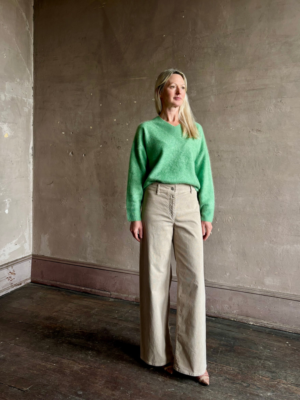 Mature woman wearing Guest in Residence Grizzly Double V Sweater Highland Green brushed cashmere with symmetrical front-and-back V-necklines