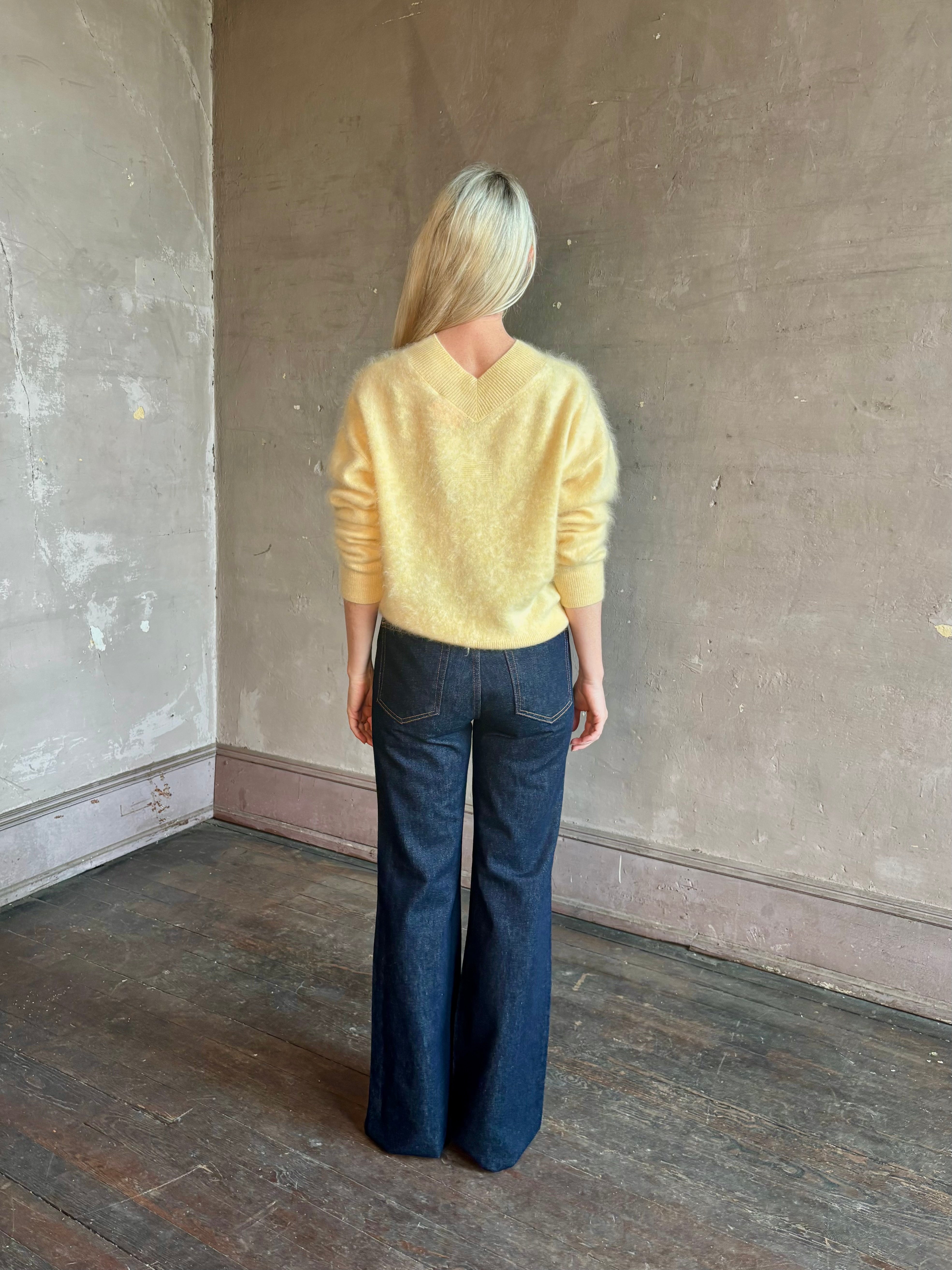 Mature woman wearing Guest in Residence Grizzly Double V Sweater in Butter brushed cashmere front-and-back V-necklines long sleeves