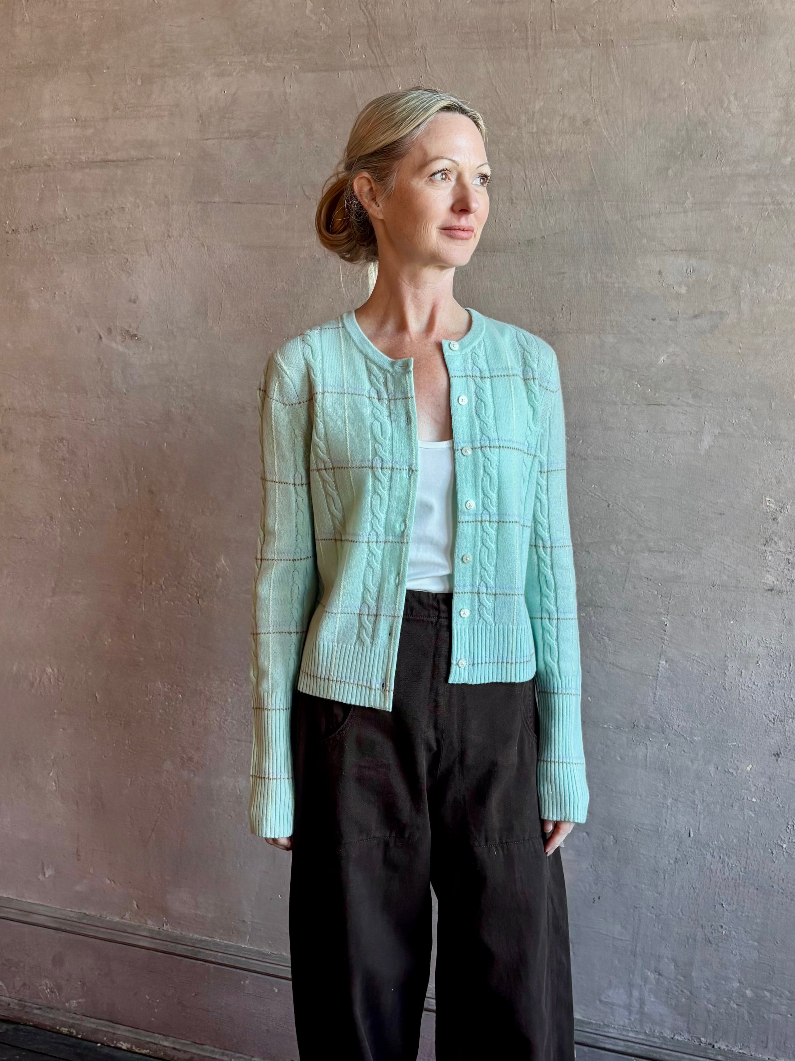 Image of woman wearing premium GUEST IN RESIDENCE Jane Mongolian cashmere Cardigan in Sea glass plaid with textured cable details.