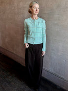 Image of woman wearing premium GUEST IN RESIDENCE Jane Mongolian cashmere Cardigan in Sea glass plaid with textured cable details.