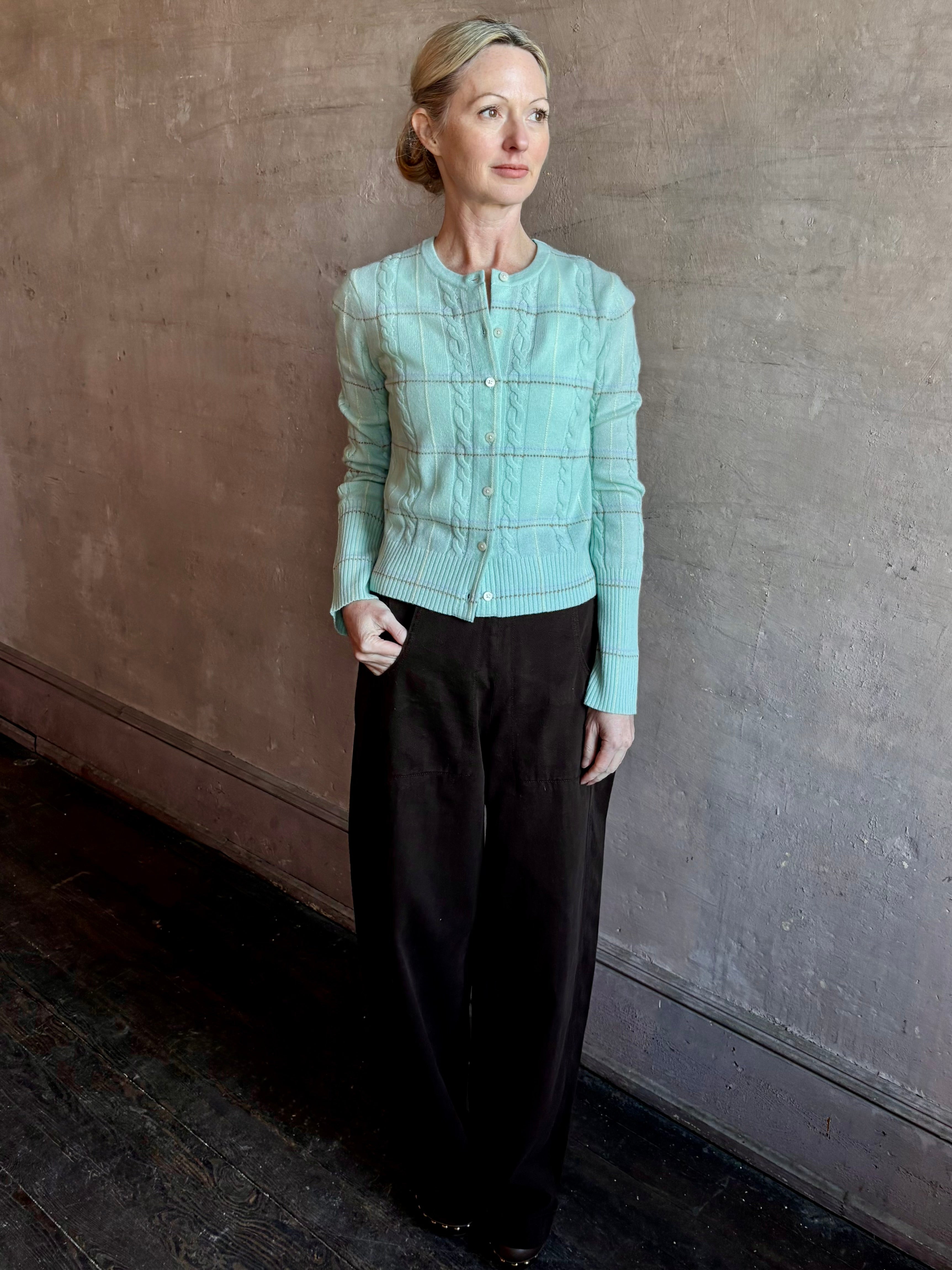 Image of woman wearing premium GUEST IN RESIDENCE Jane Mongolian cashmere Cardigan in Sea glass plaid with textured cable details.