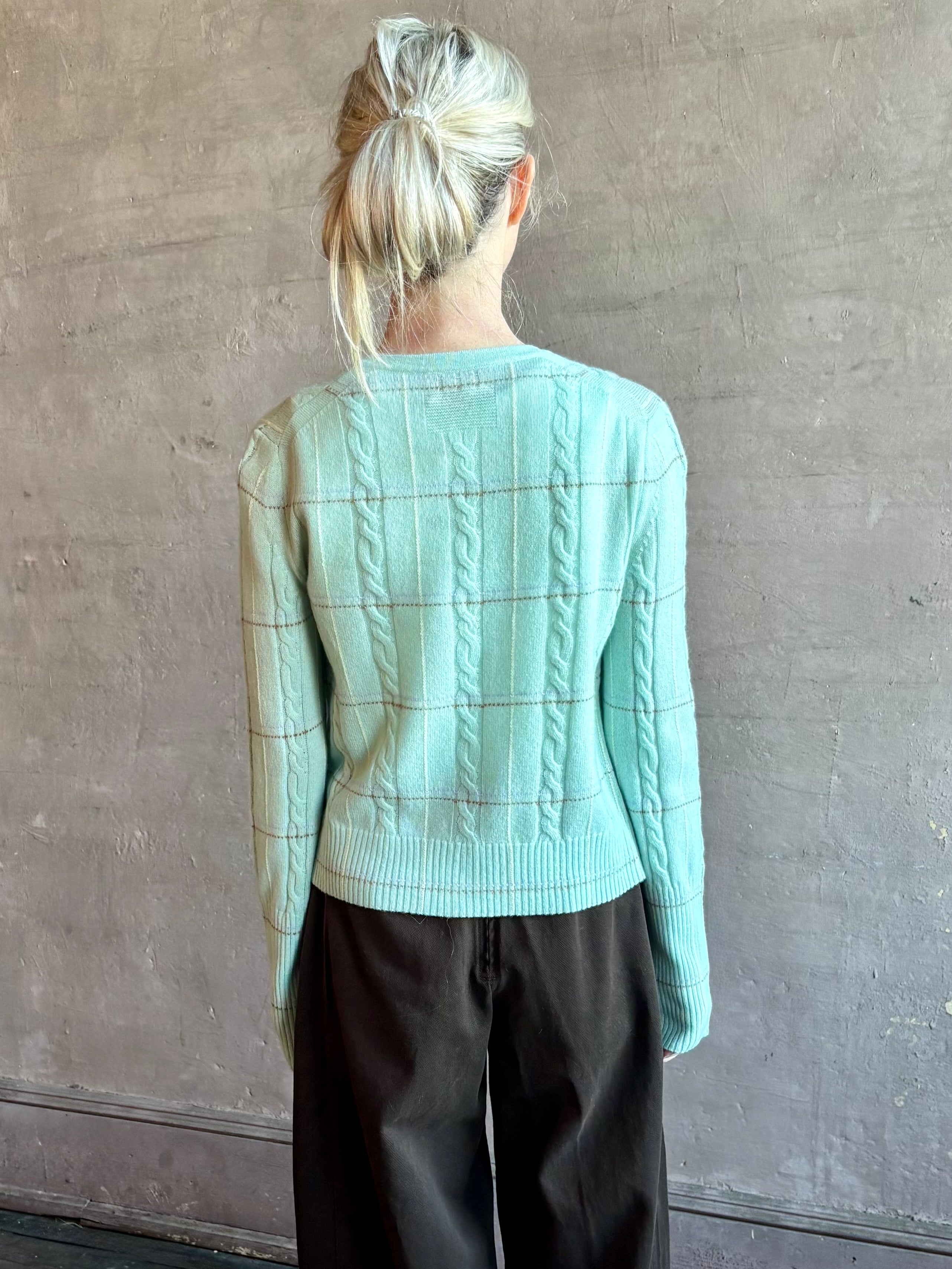 Image of woman wearing premium GUEST IN RESIDENCE Jane Mongolian cashmere Cardigan in Sea glass plaid with textured cable details.