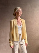 Mature woman wearing Guest in Residence Rib Stealth Cardigan layering essential in butter yellow cashmere linen blend