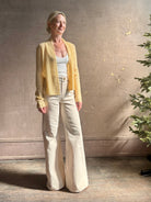 Mature woman wearing Guest in Residence Rib Stealth Cardigan layering essential in butter yellow cashmere linen blend