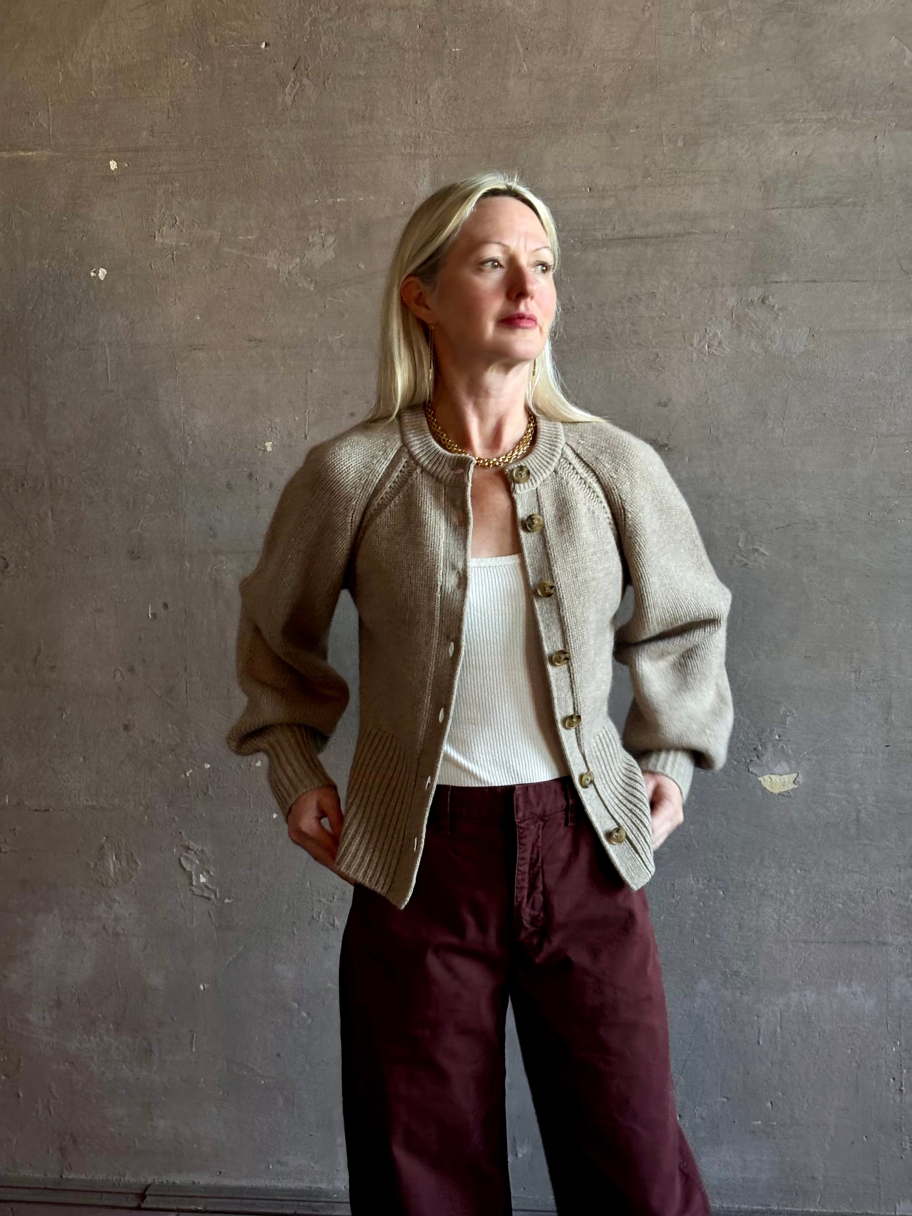 Mature woman wearing Guest in Residence Sculpted Cardigan in Taupe medium gauge cashmere raglan sleeves button front fitted waist softly structured