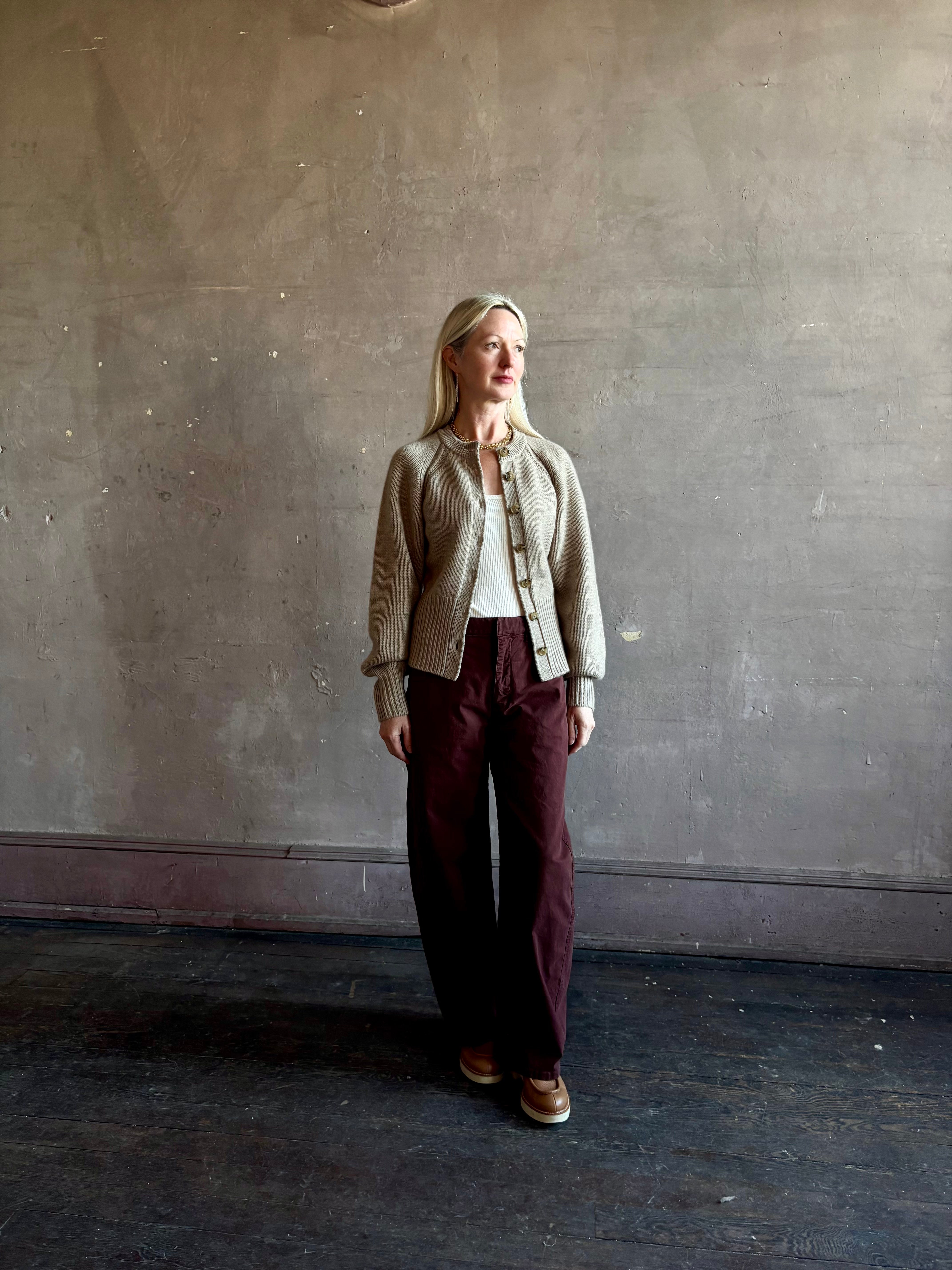 Mature woman wearing Guest in Residence Sculpted Cardigan in Taupe medium gauge cashmere raglan sleeves button front fitted waist softly structured