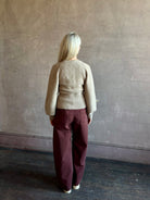 Mature woman wearing Guest in Residence Sculpted Cardigan in Taupe medium gauge cashmere raglan sleeves button front fitted waist softly structured
