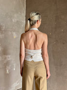 Mature woman wearing Guest in Residence premium cashmere halter top backless white expert tailoring