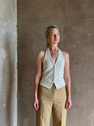 Mature woman wearing Guest in Residence premium cashmere halter top vest with expert tailoring v-neck