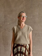 Mature woman wearing Guest in Residence taupe Ribbed sweater with v-neck luxury Mongolian cashmere sleeveless