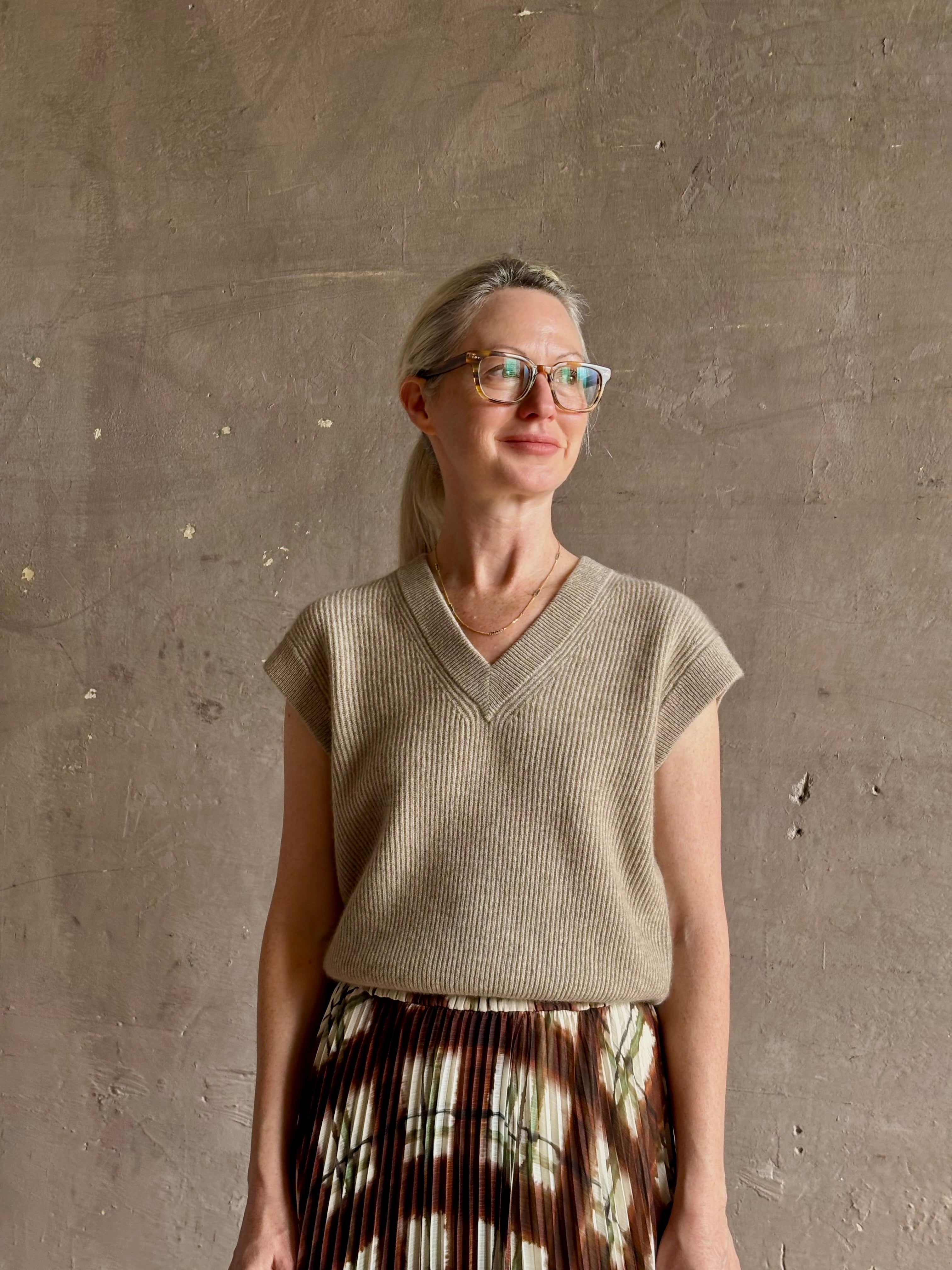 Mature woman wearing Guest in Residence taupe Ribbed sweater with v-neck luxury Mongolian cashmere sleeveless