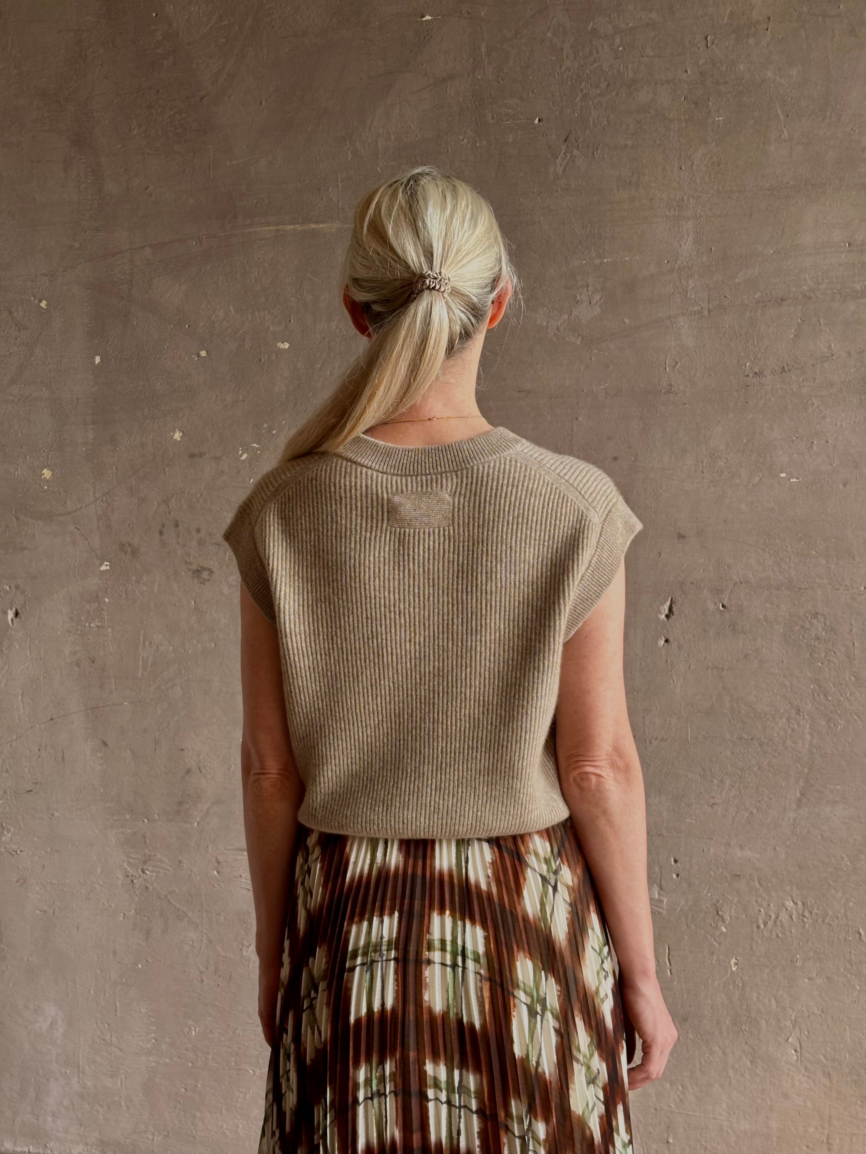 Mature woman wearing Guest in Residence taupe Ribbed sweater with v-neck luxury Mongolian cashmere sleeveless
