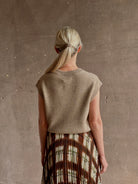 Mature woman wearing Guest in Residence taupe Ribbed sweater with v-neck luxury Mongolian cashmere sleeveless