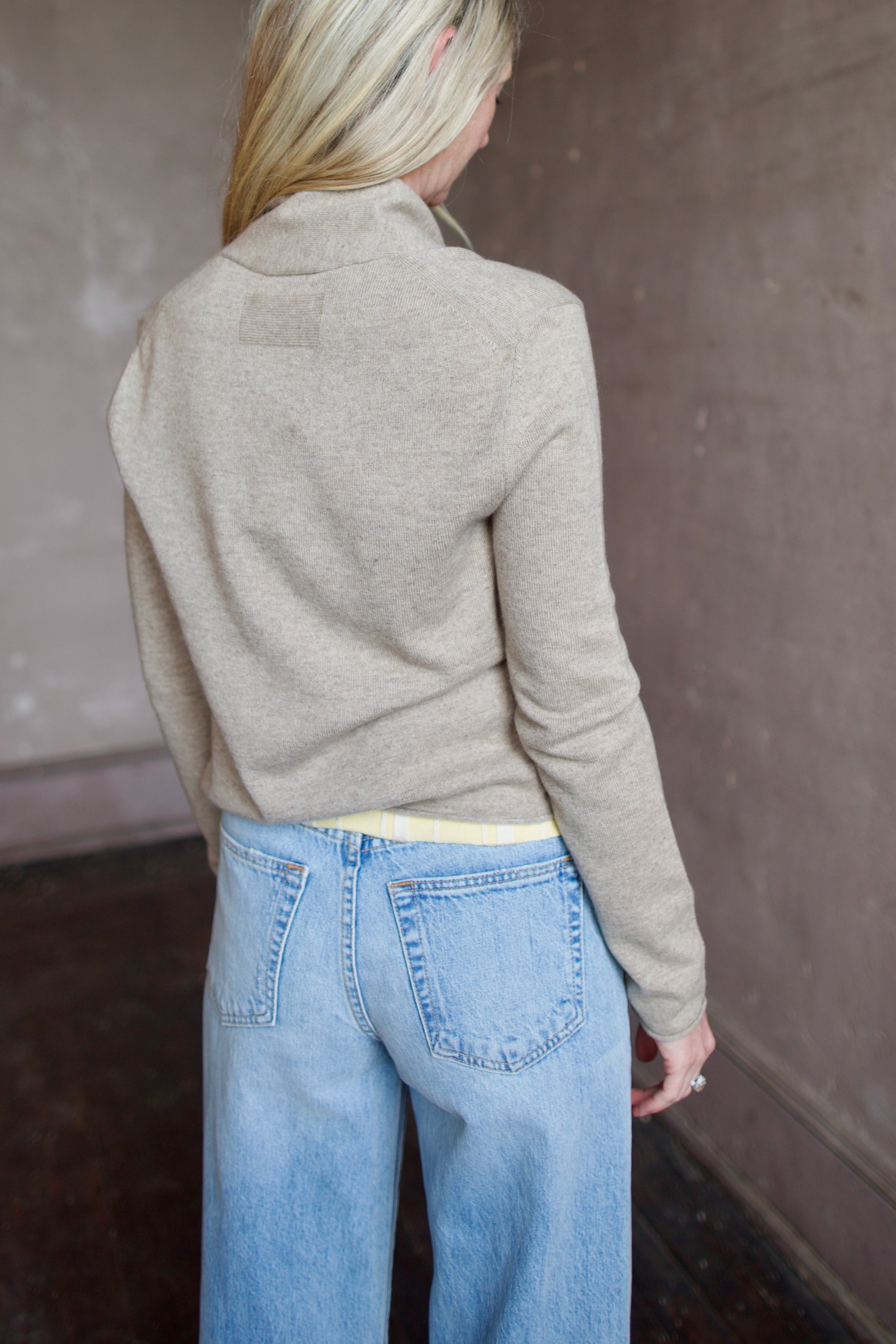 Woman wearing a taupe effortless layering stealth cashmere cardigan by Guest In Residence for timeless elegance