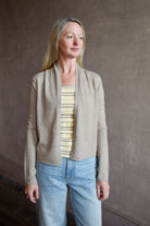 Model wearing a taupe effortless layering stealth cashmere cardigan by Guest In Residence for timeless elegance