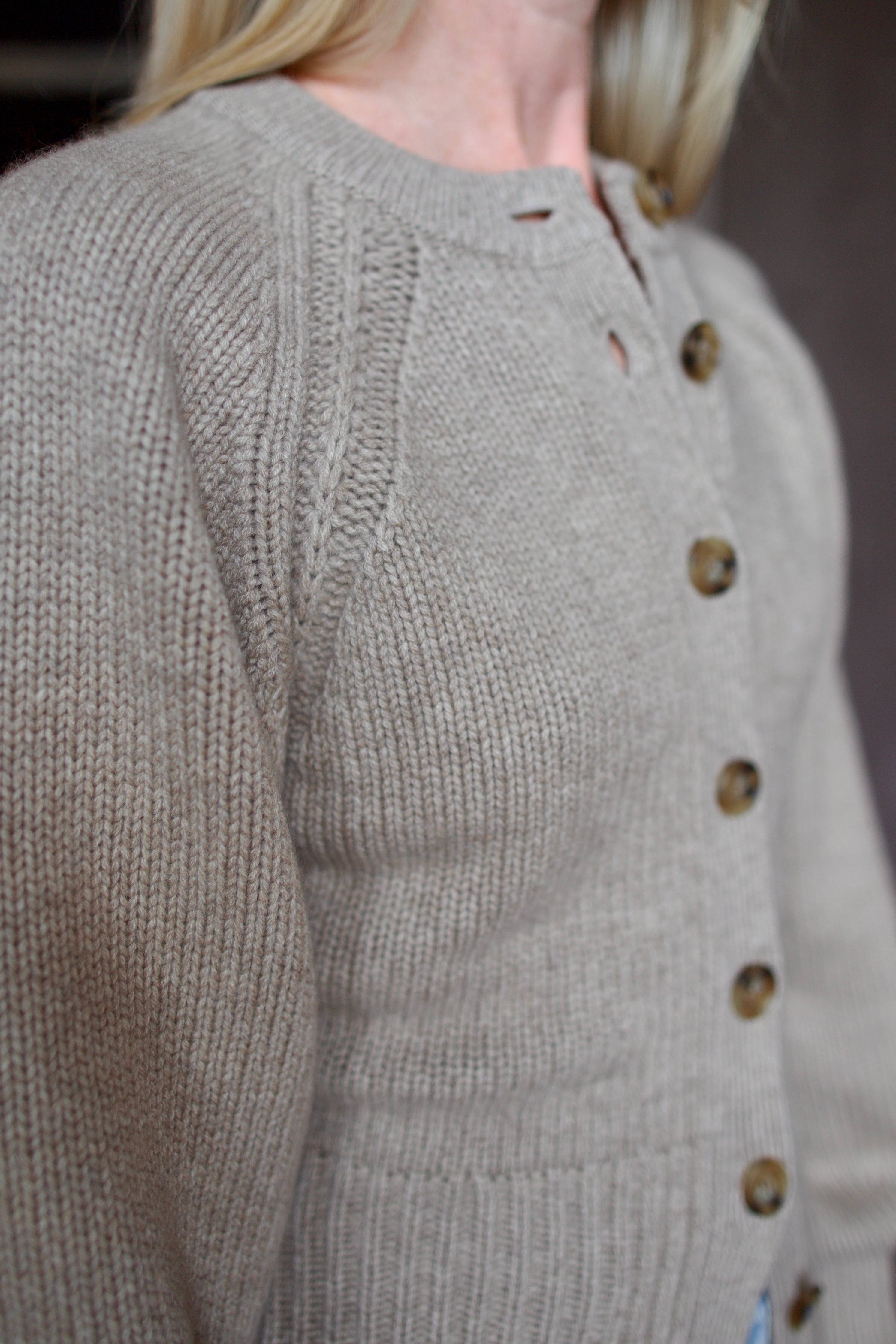 Close up of beige Guest in Residence cashmere cardigan with Slvrlake denim 