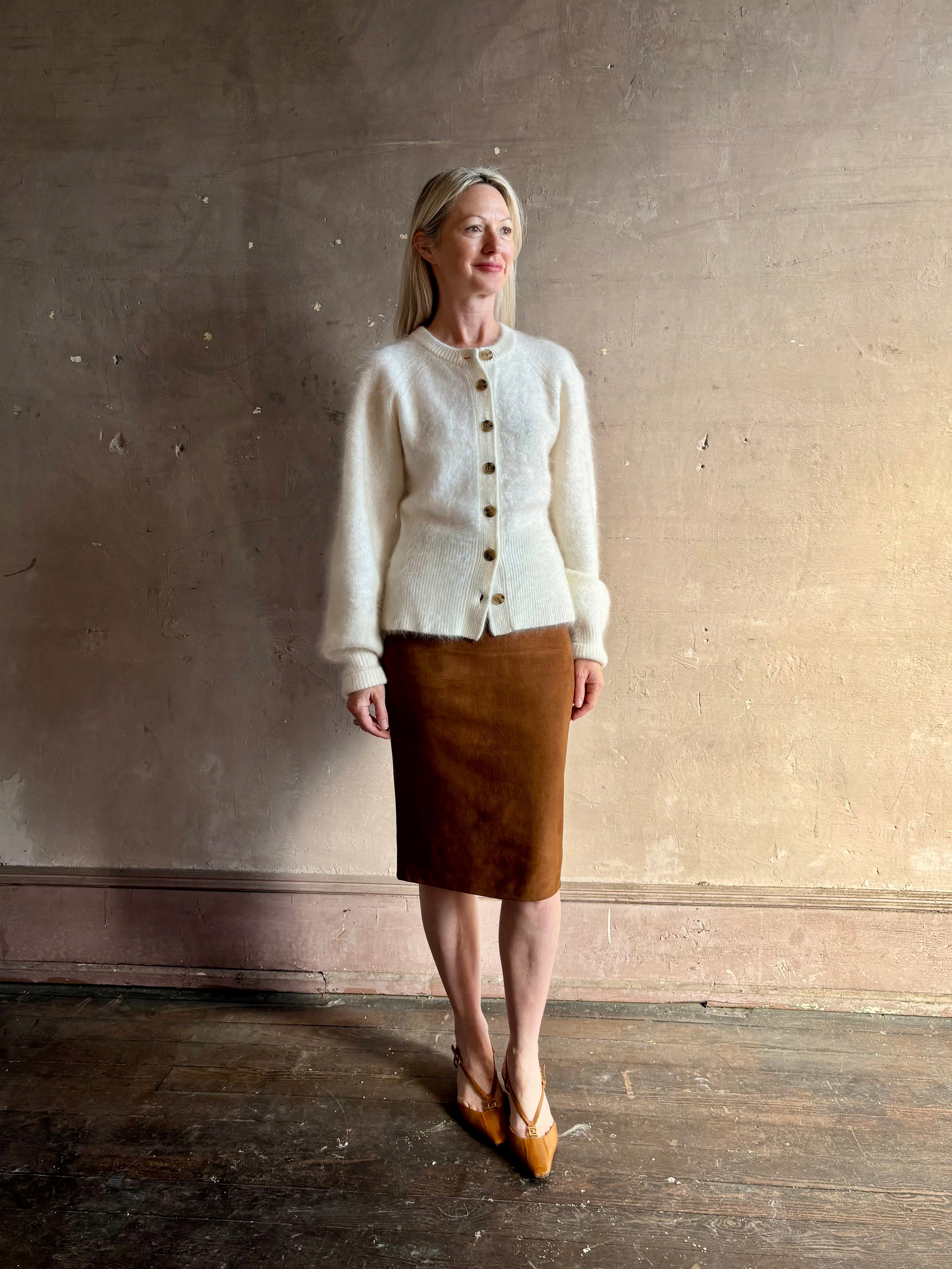 Mature woman wearing Guest in Residence’s Grizzly Sculptured Cream brushed cashmere button front cardigan ribbed trims soft luxury layer