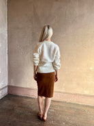 back image of Mature woman wearing a cream-colored brushed cashmere cardigan  by Gigi Hadid Guest in Residence with feminine sihlouette and fitted waistband
