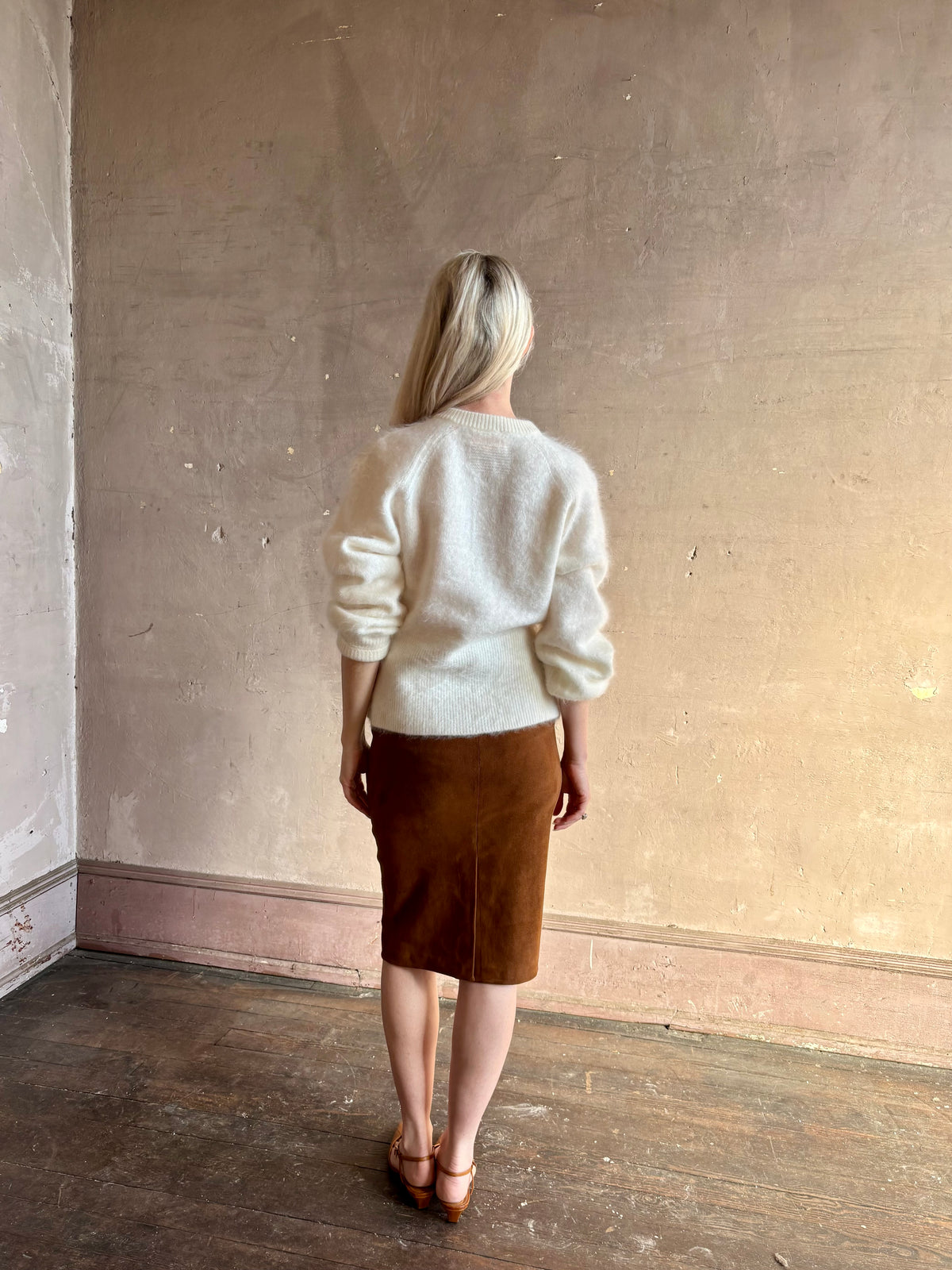 back image of Mature woman wearing a cream-colored brushed cashmere cardigan  by Gigi Hadid Guest in Residence with feminine sihlouette and fitted waistband